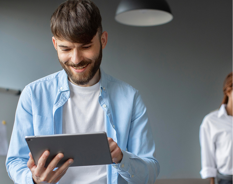 Man smiling at a tablet during a webinar quiz